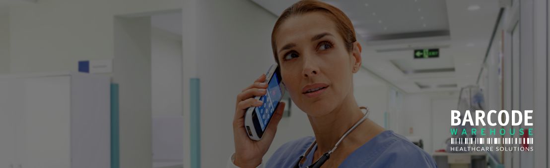 Healthcare professional holding connectivity mobile device to ear in a hospital setting